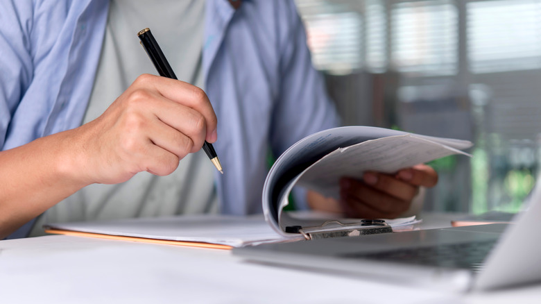 Reviewing notes to make a decision.