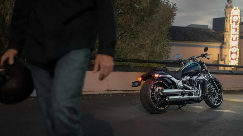 2024 Breakout in black, parked, rider walking in foreground with helmet