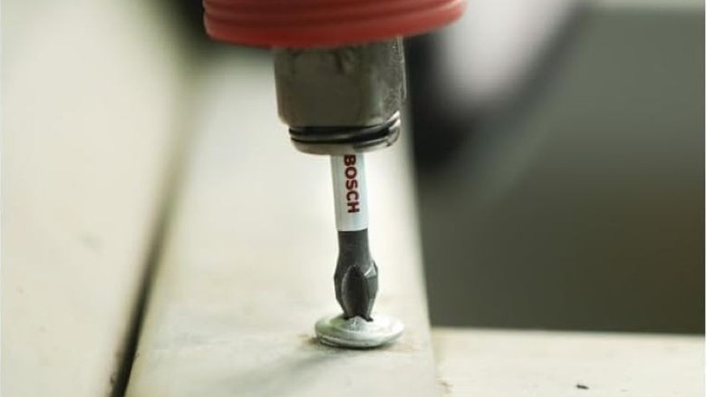 Close up of Bosch impact driver bit driving a screw in