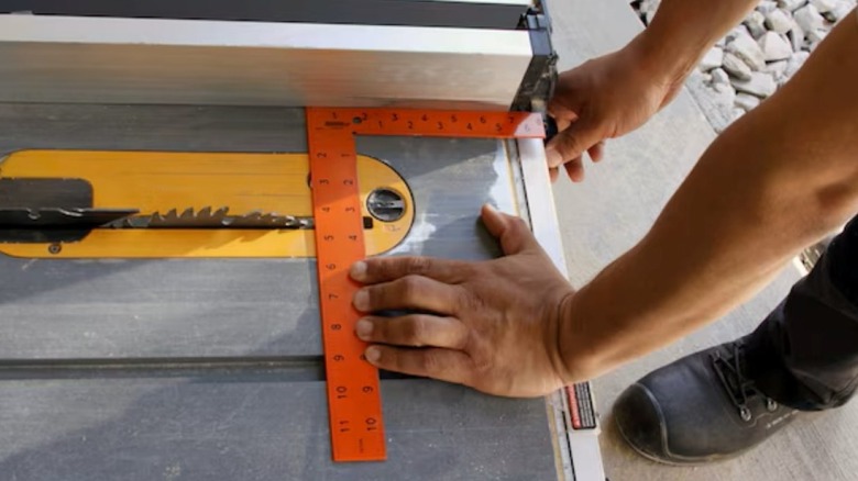 Using the Johnson Level steel carpenter square to align a table saw fence.