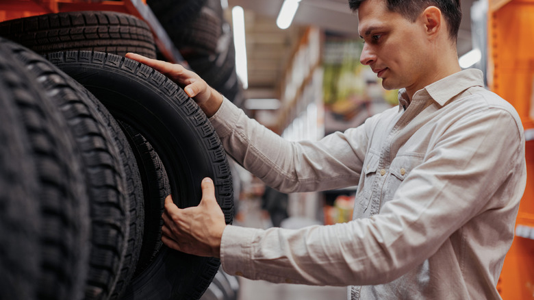 Man choosing new tires in a shop
