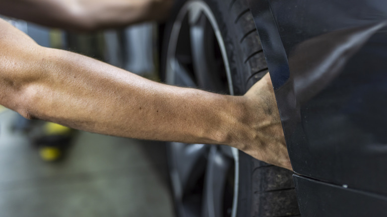 person grabbing tire