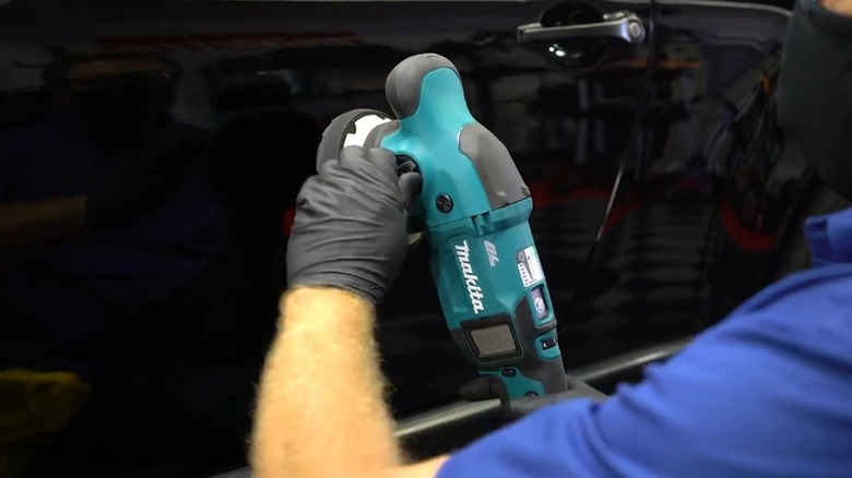 person using makita polisher