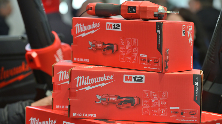 A stack of Milwaukee brand tool boxes containing M12 Pruning Shears