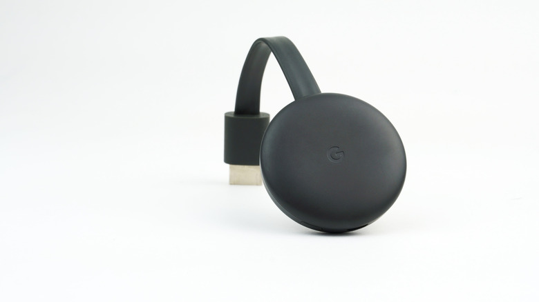 Chromecast with HDMI dongle on white background