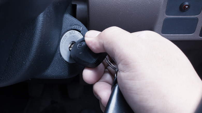 Driver holding the key in the ignition