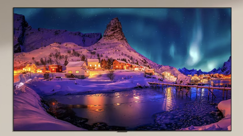 An LG evo G6 TV mounted on a brown wall showing a high-def photo of a winter scene