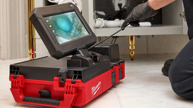 Milwaukee M12 drain camera being used by a professional