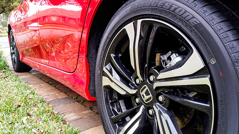 Close-up of a Bridgestone tire installed on a red Honda