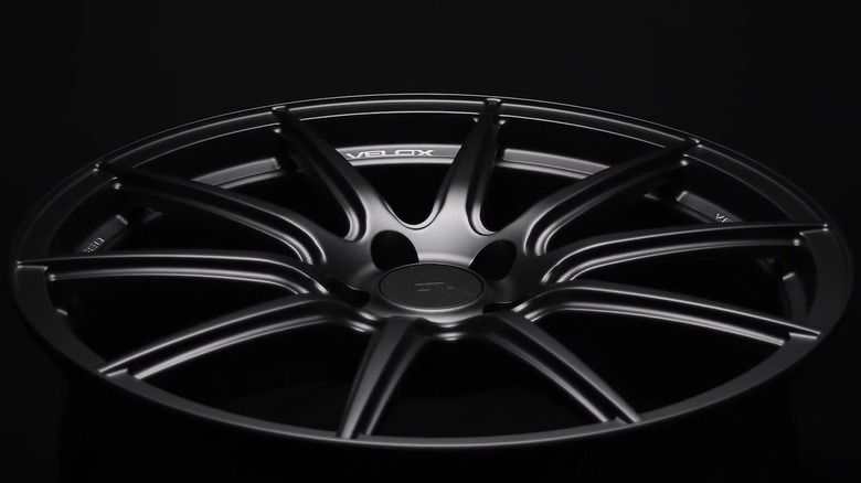 Close-up of a black Velox wheel on a black background