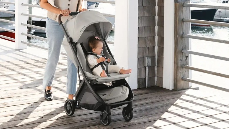 woman pushing child in UppaBaby Mini V3 lightweight stroller