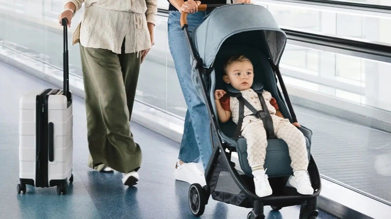 woman pushing child through airport in Uppababy Minu V3 lightweight stroller