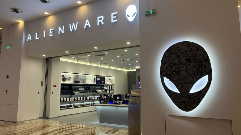An Alienware store in a mall with its logo and store name lit up