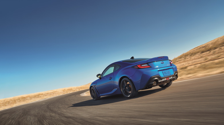 Blue 2024 Subaru BRZ tS cornering on a desert circuit