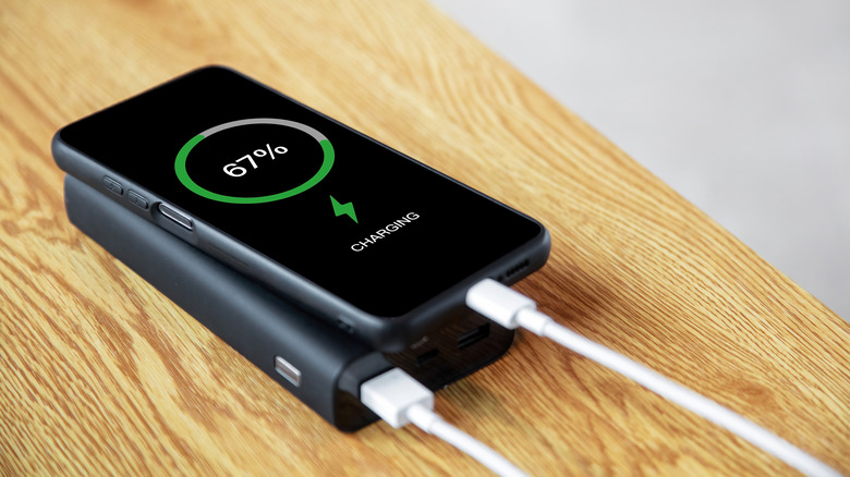 A power bank charging a phone