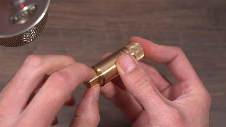 A person setting up the MetMo Piston, microphone in the corner