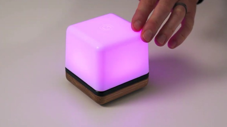 User's hand adjusting a setting on a Luma³.