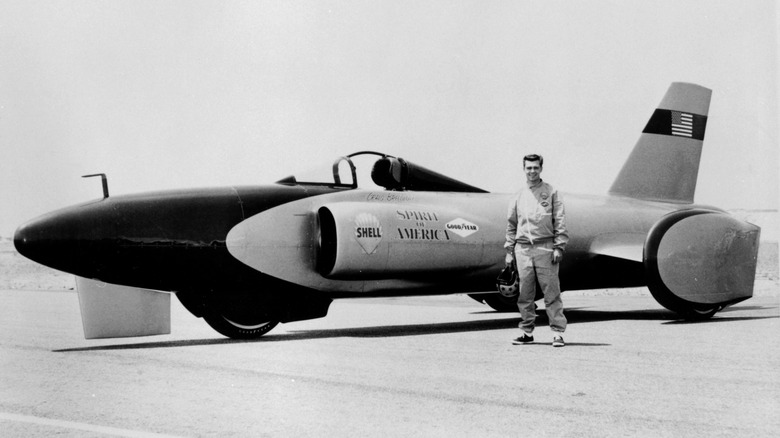 Craig Breedlove standing next the land speed car, The Spirit of America.