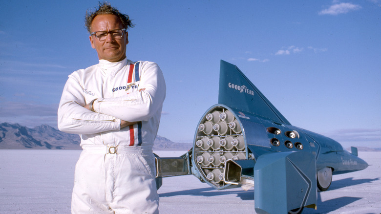 Walt Arfons standing near the rear of the Wingfoot Express 2 with many JATO rockets visible.