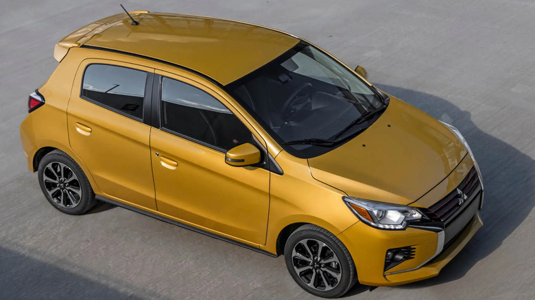 A yellow Mitsuhishi Mirage on the street