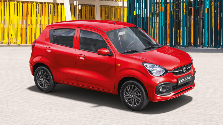 A red Suzuki Celerio parked on the street.