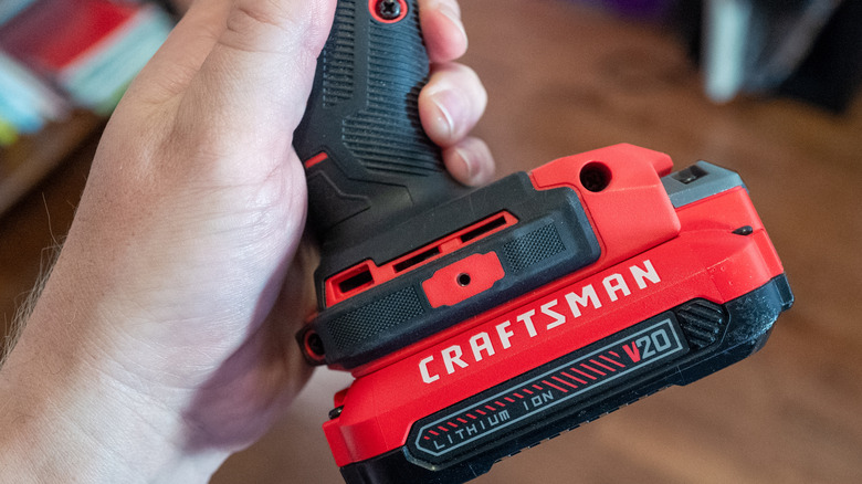 A person holding a Craftsman power drill