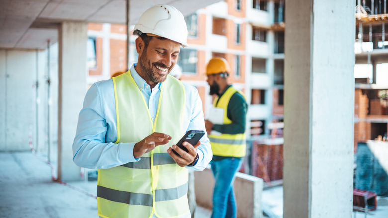Person using a mobile device at a construction site