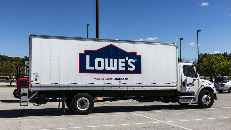 Lowe's Home Improvement delivery truck driving through a parking lot