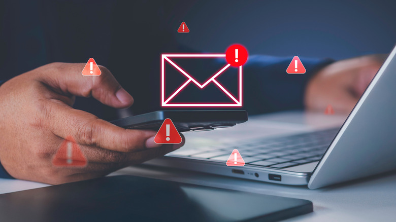 Person click email with red warning icons