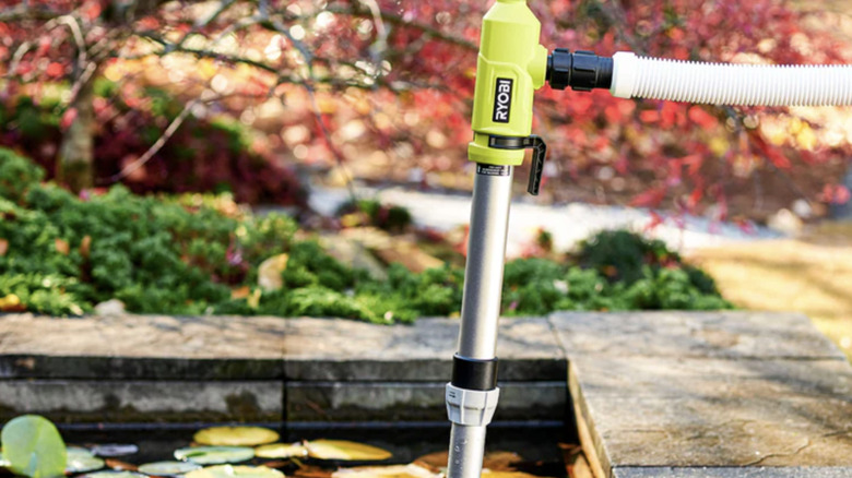 The Ryobi 18V One+ Telescoping Pole Pump being used in an outdoor water feature
