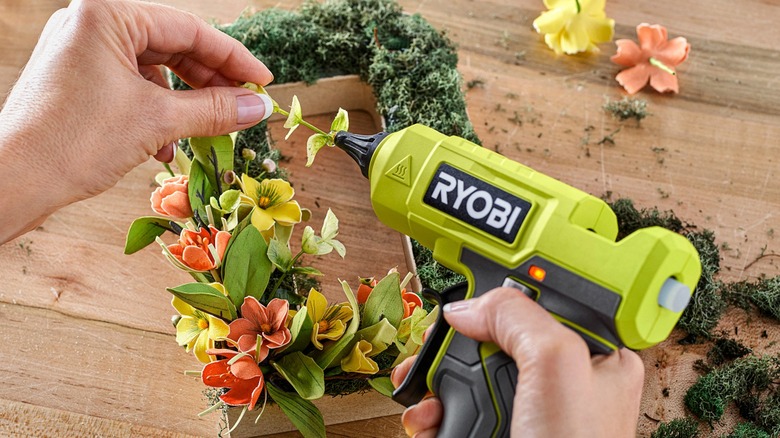 person gluing flowers