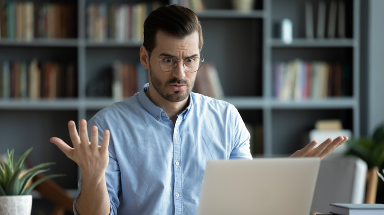 Person frustrated with laptop