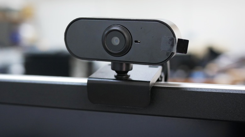 black webcam mounted on top of a computer monitor