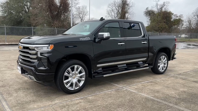 A Black 2023 Chevrolet Silverado High Country in a parking lot.