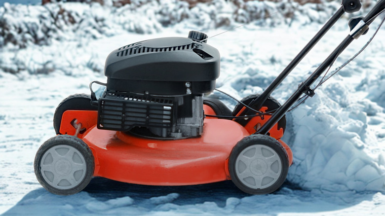 A lawn mower on a snowy landscape.