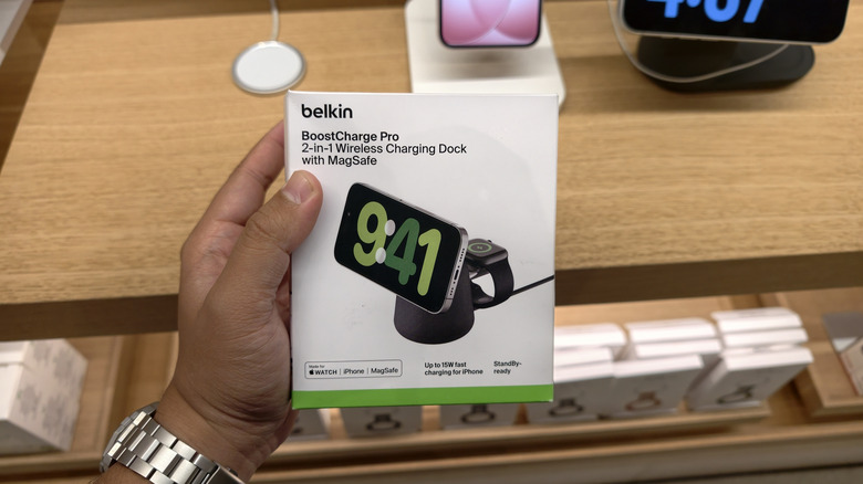 Person holding a Belkin wireless charging dock