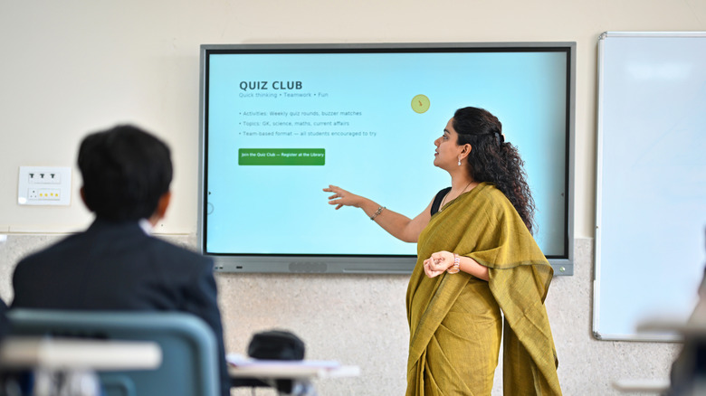 A teacher using a smart whiteboard