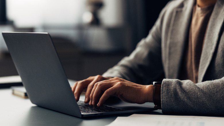 Man typing on laptop