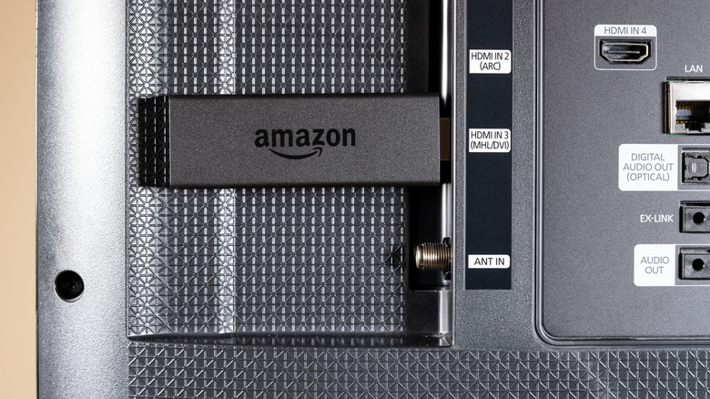 Fire TV Stick plugged into back of TV