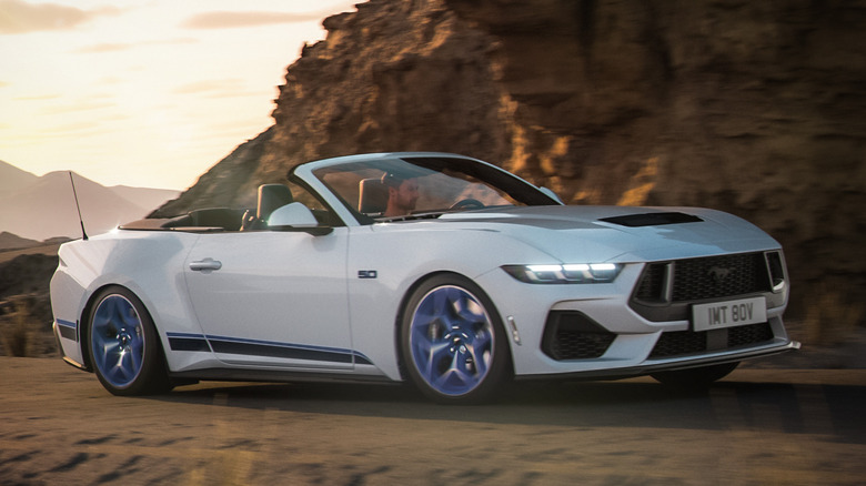 Front 3/4 view of Ford Mustang California Special convertible cornering, white exteior with blue wheels