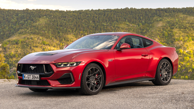 Front 3/4 view of Ford Mustang parked in European forested hillside setting