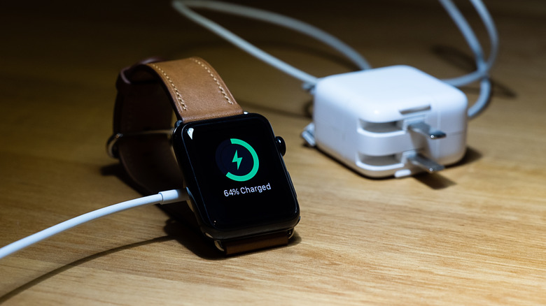 Apple Watch charging on a wooden table
