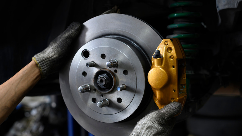 Mechanic installing brake calipers