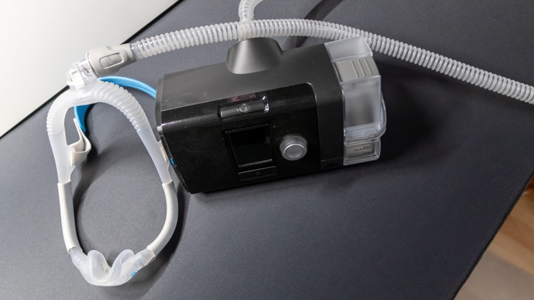 CPAP machine on black surface.