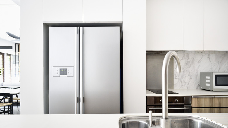 Refrigerator in a modern well-lit kitchen.