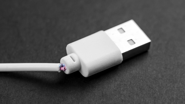 A USB cable with exposed wiring.
