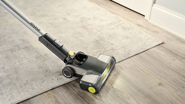 Ryobi vacuum running over a rug and wood flooring