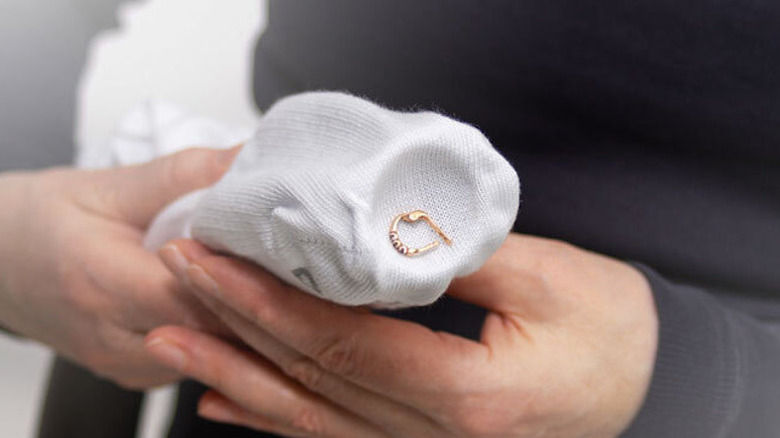 Person using a Ryobi vacuum to retrieve an earring