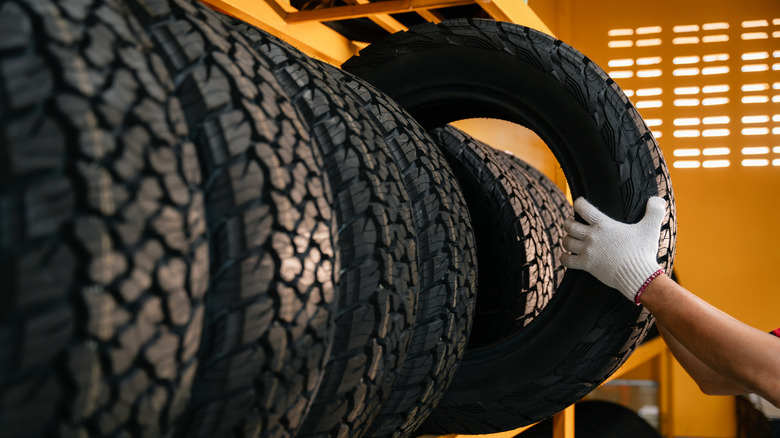 man getting tire from storage
