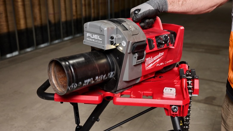 A Milwaukee roll groover with a pipe connected.